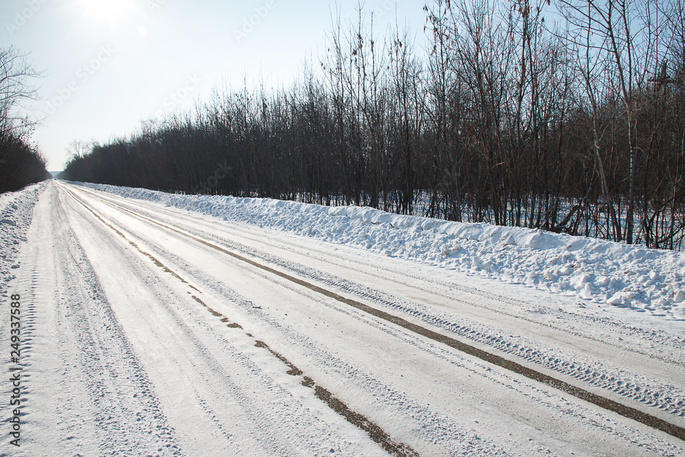 Winter road. the track of the car leading into the distance