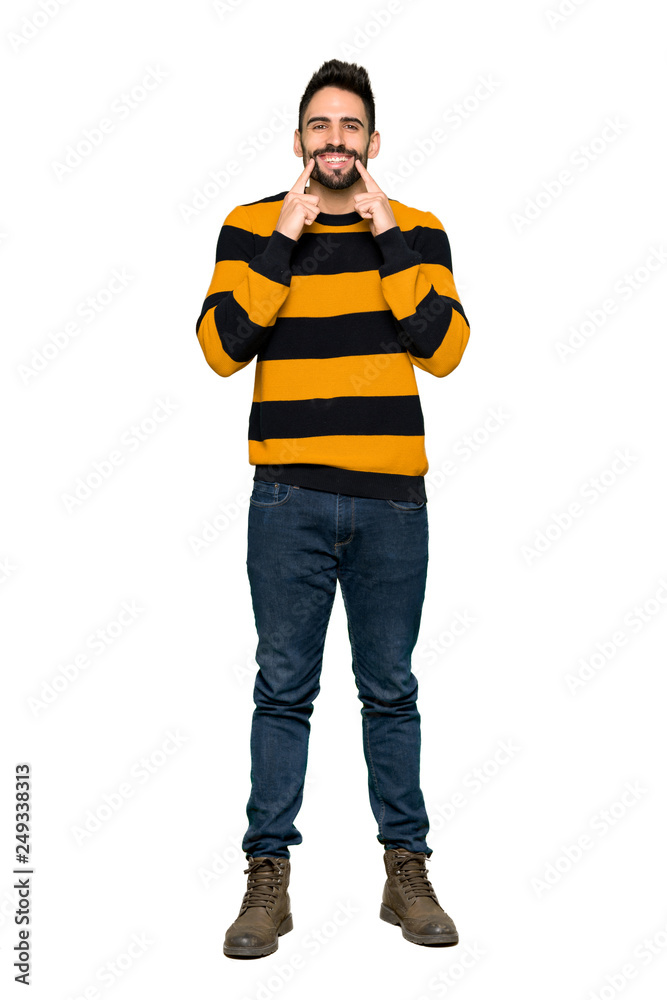 Full-length shot of Handsome man with striped sweater smiling with a happy and pleasant expression on isolated white background