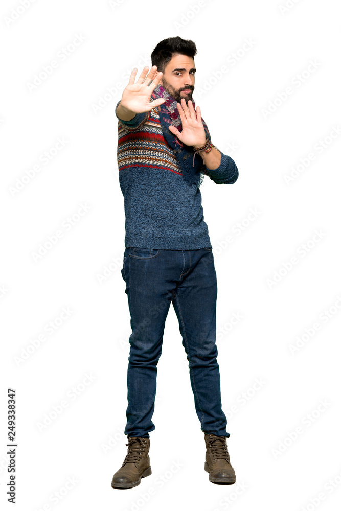 Full-length shot of Hippie man is a little bit nervous and scared stretching hands to the front on isolated white background Full-length shot of Hippie man is a little bit nervous and scared stretching hands to the front on isolated white background