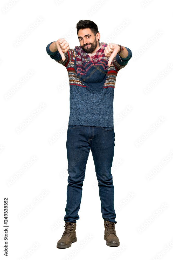 Full-length shot of Hippie man showing thumb down with both hands on isolated white background Full-length shot of Hippie man showing thumb down with both hands on isolated white background