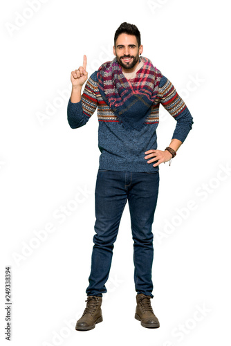 Full-length shot of Hippie man showing and lifting a finger in sign of the best on isolated white background
