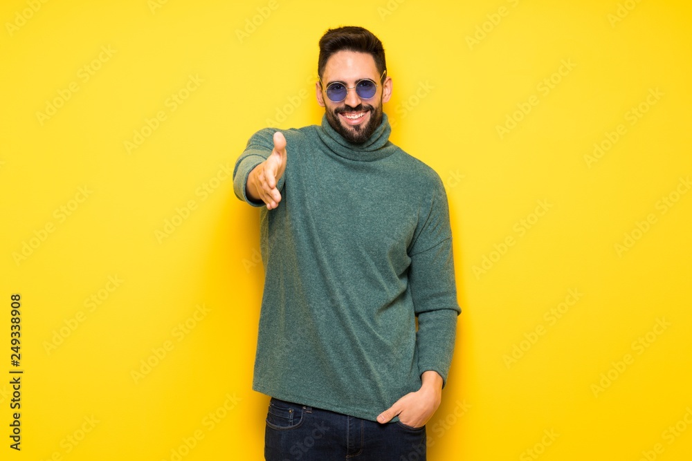 Handsome man with sunglasses shaking hands for closing a good deal Handsome man with sunglasses shaking hands for closing a good deal