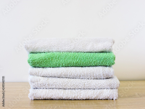 Stack of colorful bath towels  on white background.Pile of rainbow colored towels isolated.Top view.Hygiene, fabric,spa and textile concept.