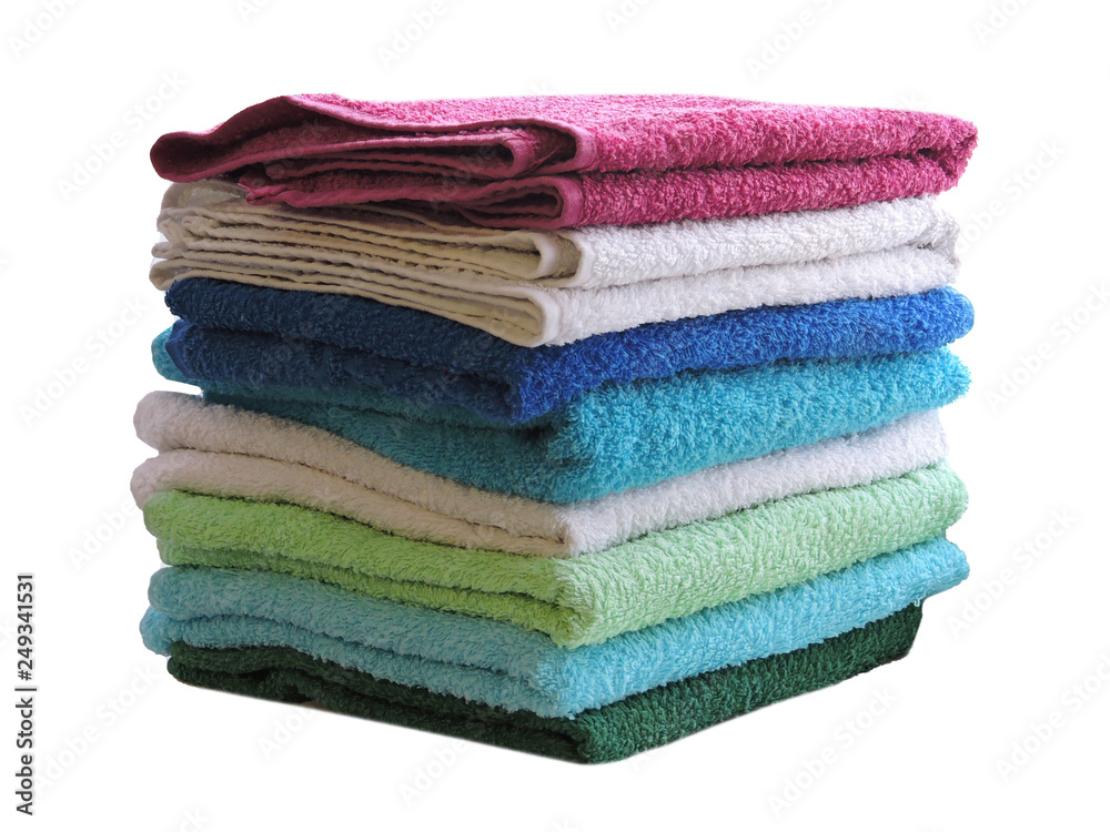 Stack of colorful bath towels  on white background.Pile of rainbow colored towels isolated.Top view.Hygiene, fabric,spa and textile concept.