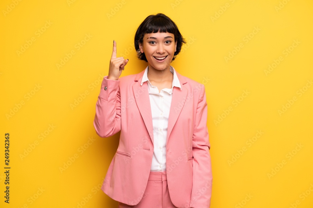 Modern woman with pink business suit intending to realizes the solution while lifting a finger up Modern woman with pink business suit intending to realizes the solution while lifting a finger up