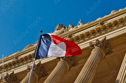 Fototapeta Naklejka Na Ścianę i Meble -  French flag on a windy day on a classic style building