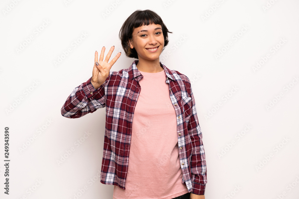 Young woman with short hair happy and counting four with fingers Young woman with short hair happy and counting four with fingers