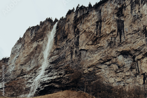 Waterfall in Lauterbrunnen, Switzerland. Winter landscape, cold.