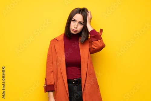 Young woman with coat with an expression of frustration and not understanding © luismolinero