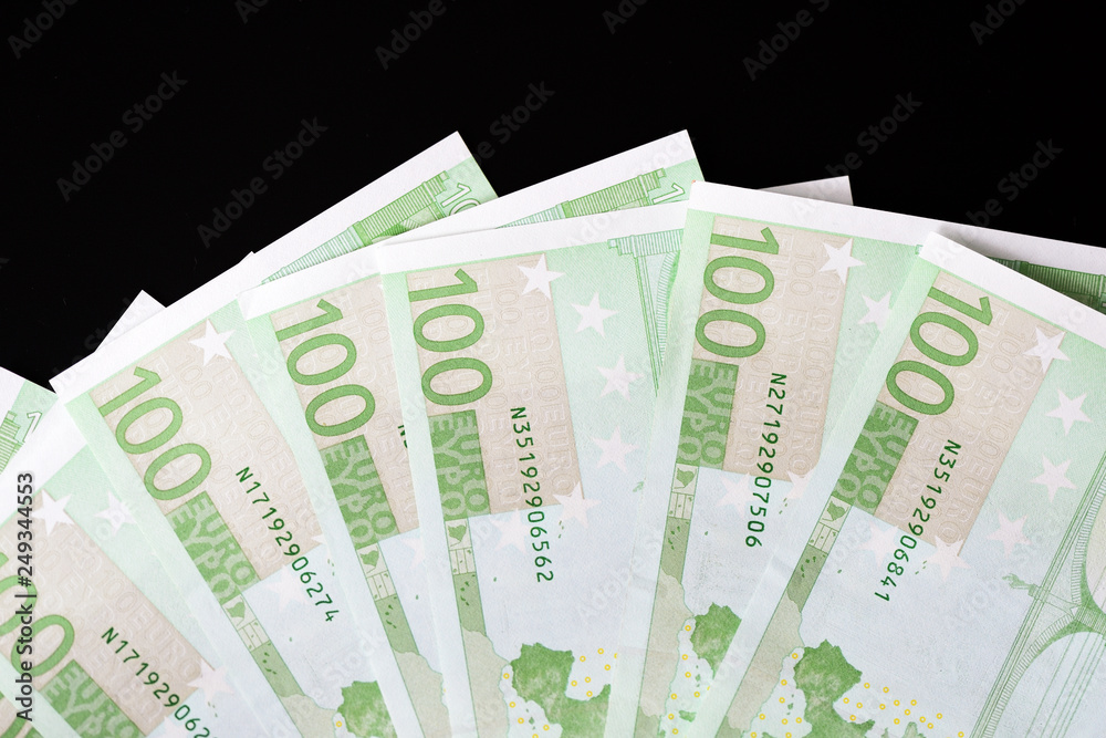 One Hundred euro banknotes on a dark background close up One Hundred euro banknotes on a dark background close up