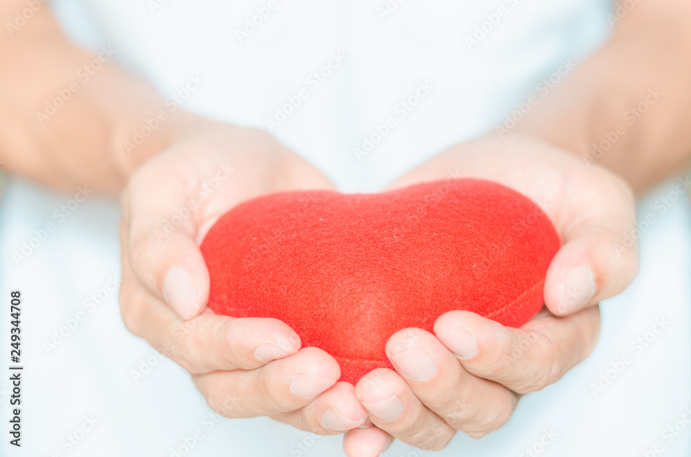 handsome man holding red heart in hands giving for love life healthy care medicine hospital concept and lovely romantic for valentines day.