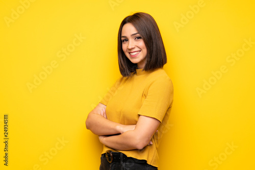 Portrait of young woman over white wall photo