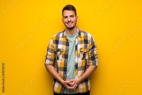 Wallpaper Mural Handsome man over yellow wall laughing looking to the front Torontodigital.ca