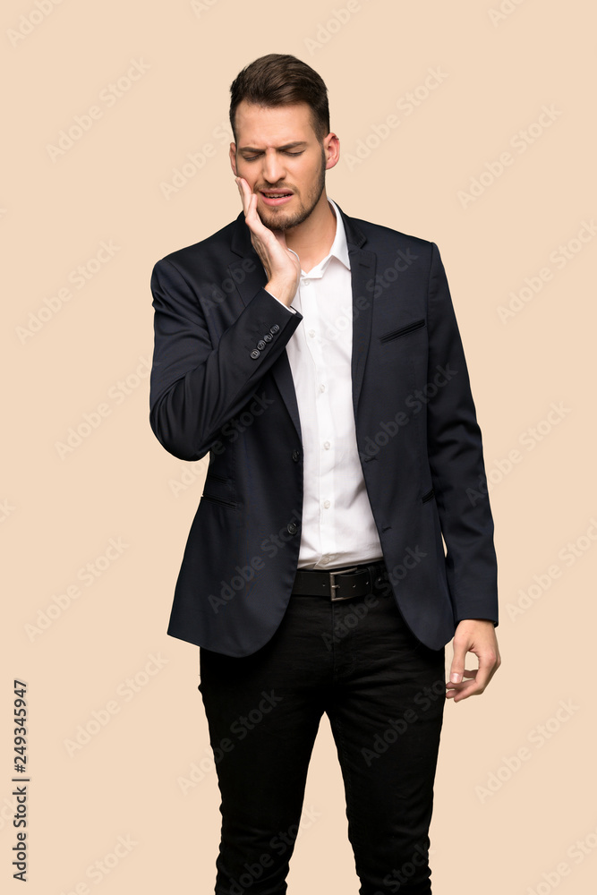 Handsome business man with toothache over ocher background Handsome business man with toothache over ocher background