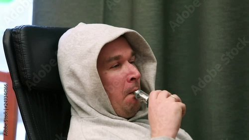 Man smoking electronic cigarette vapor. harm to health and bad habits