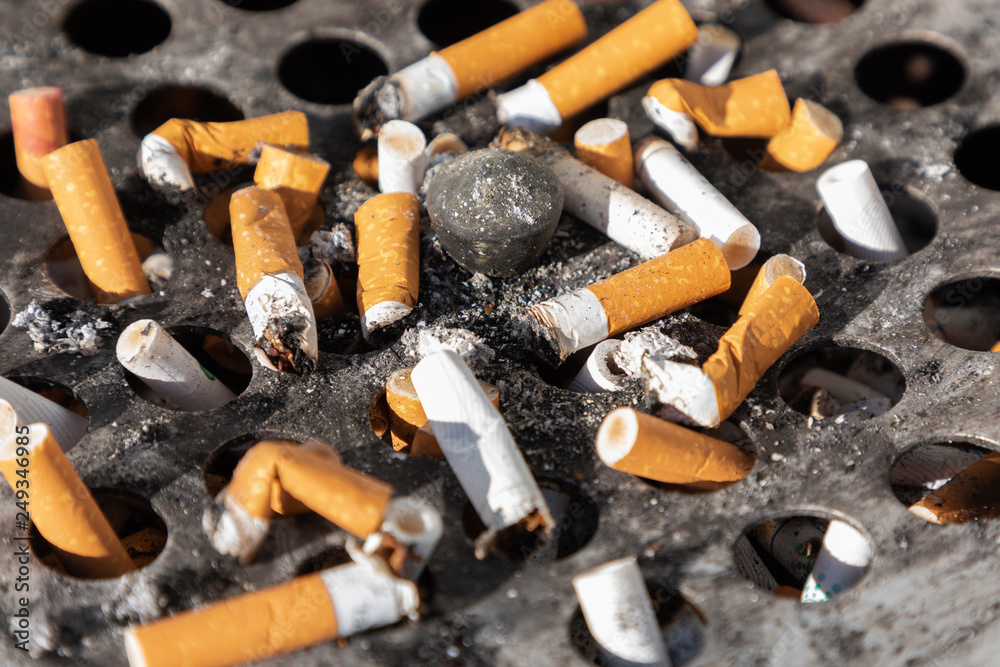 Cigarette ashtray close-up dirty ash ugly round metal Cigarette ashtray close-up dirty ash ugly round metal