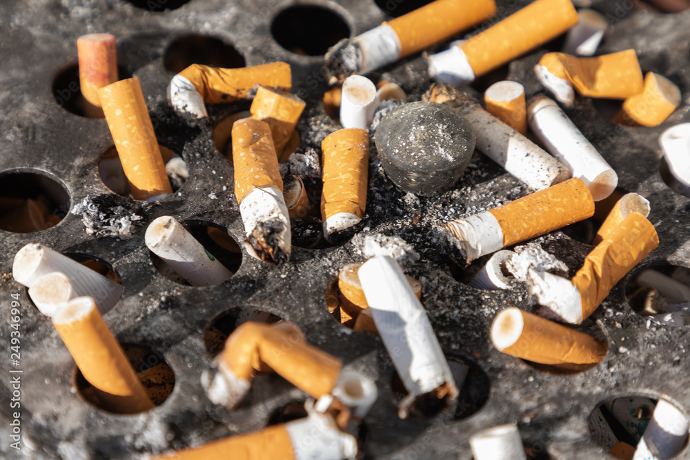 Cigarette ashtray close-up dirty ash ugly round metal Cigarette ashtray close-up dirty ash ugly round metal