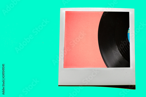 Instant photo on colored blue soft background. Polaroid vinyl