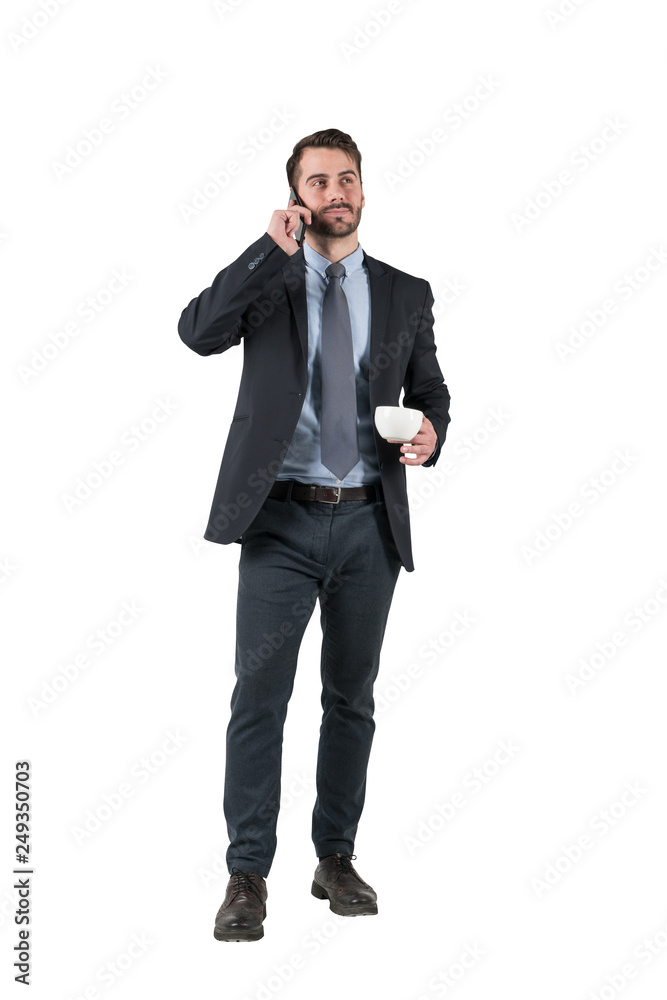 Businessman with cup talking on phone, isolated Businessman with cup talking on phone, isolated