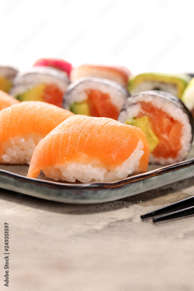 close up of sashimi sushi set with chopsticks and soy - sushi roll with salmon and sushi roll with smoked eel close up of sashimi sushi set with chopsticks and soy - sushi roll with salmon and sushi roll with smoked eel