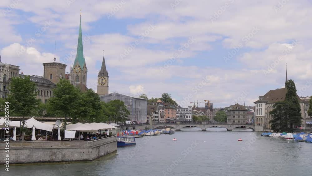 Impressive Views of the towers of the churches of Fraumunster and St. Peter from the Limmat river in Zurich. Impressive Views of the towers of the churches of Fraumunster and St. Peter from the Limmat river in Zurich.