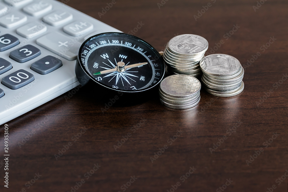 Caculator , compass and Stack of coins with copay space
