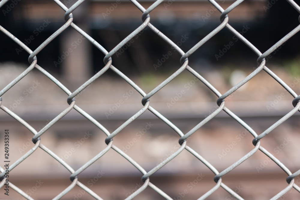 steel wire net fence with blurred green background steel wire net fence with blurred green background