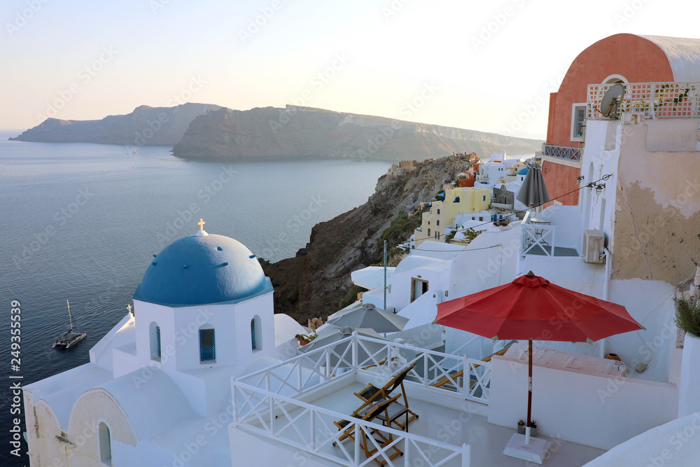 Greece Santorini island in Cyclades. Panoramic view of Caldera sea with ship in background.