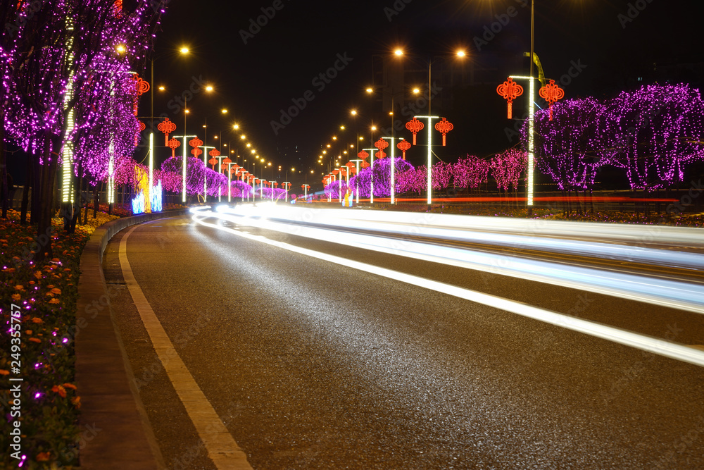 Highway with Colorful Lights in Spring Festival.abstract image of blur motion of cars on the city road at night，Modern urban architecture in Chongqing, China