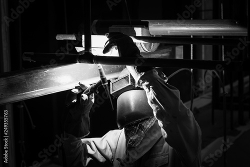 Welding steel pipe with Mig-Mag method for industrial work. Black & White concept.