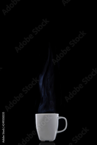 White cup with hot coffee. Steam Rising. Black background.