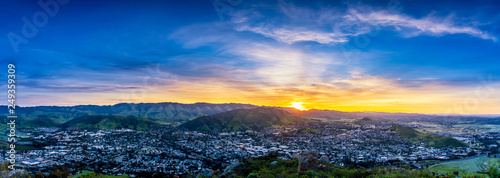 Panorama at Sunrise over City and Mountain