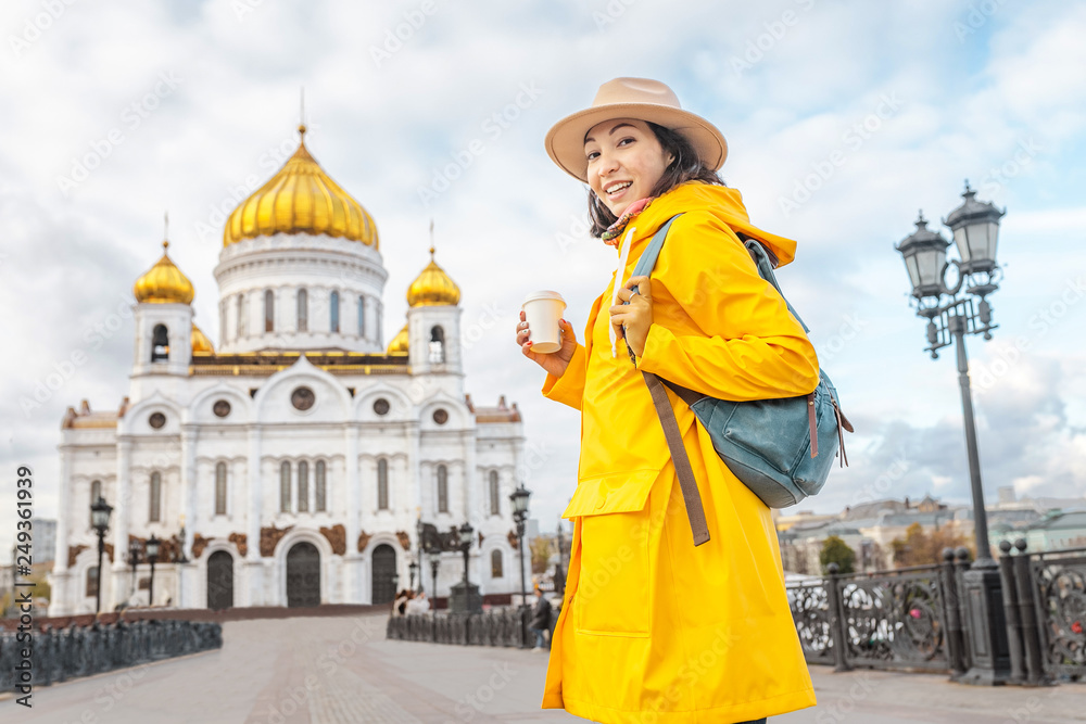 Obraz premium Happy asian tourist woman at the Cathedral of Christ the Savior. Travel and tourism in Russia and Moscow concept. Religion and faith
