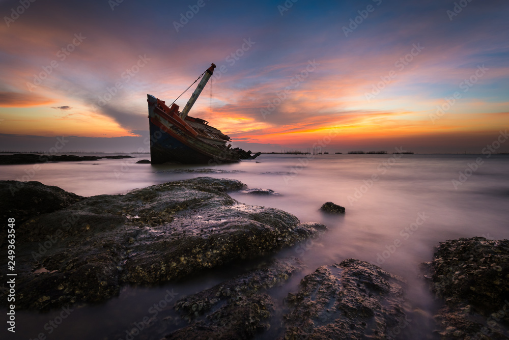 An old shipwreck or wrecked boat abandoned stand on beach An old shipwreck or wrecked boat abandoned stand on beach
