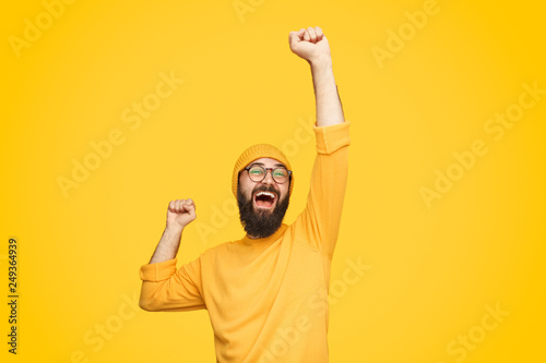 Excited bright man with fist up photo