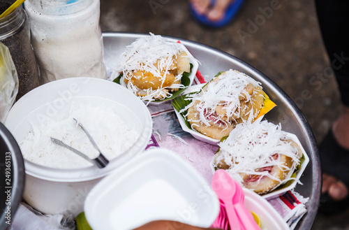 Traditional Thai Asian Dessert, Steamed Banana Cake or Pudding (Kanom Gluay, made of sticky rice, banana, sugar and grated coconut) in street food market. A cross between cake, custard and jelly. photo