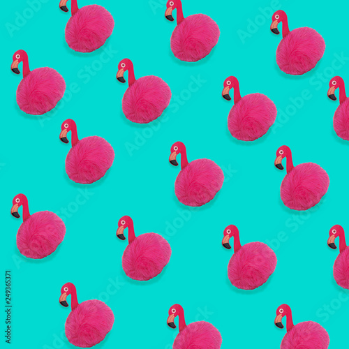 Pink Flamingo toy pattern on trendy blue background with copy space. Flamingo time for rest and relax. Creative layout summer concept for gift birthday party. Minimal style, flat lay, top view