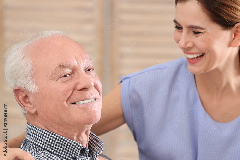 Elderly man with female caregiver at home Elderly man with female caregiver at home