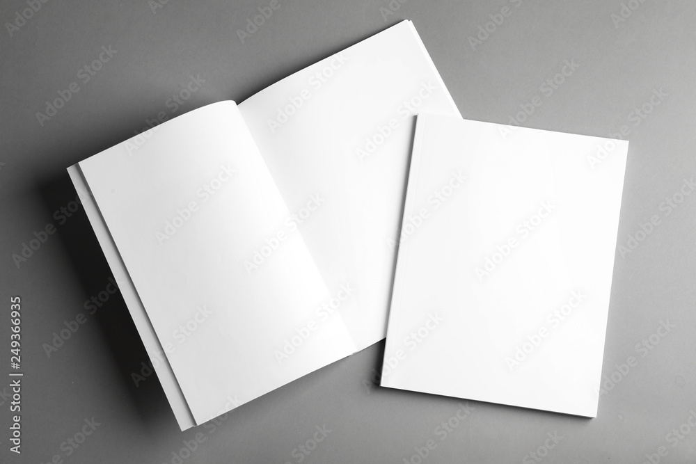 Open and closed blank brochures on grey background, top view. Mock up for design - obrazy, fototapety, plakaty 