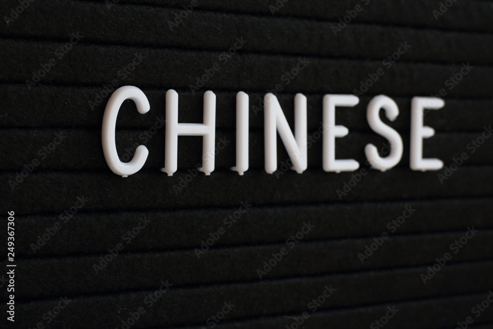 The word Chinese in white plastic letters on a black notice board The word Chinese in white plastic letters on a black notice board