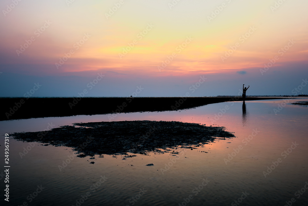 Silhouette of woman happiness on the beach in sunset and sea view. Traveling summer jobs concept. Silhouette of woman happiness on the beach in sunset and sea view. Traveling summer jobs concept.