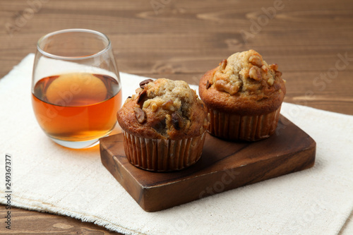 nuts cupcakes muffins with tea isolated on wooden table