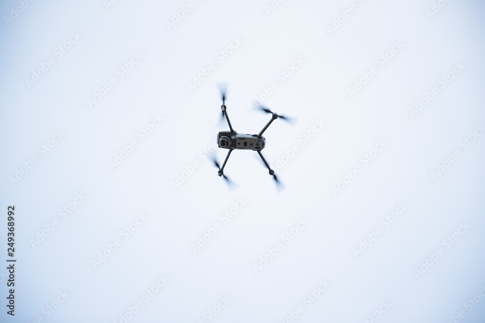 Dron overlooking the landscape in the background of a forest and village during a landing maneuver on a brick platform Dron overlooking the landscape in the background of a forest and village during a landing maneuver on a brick platform
