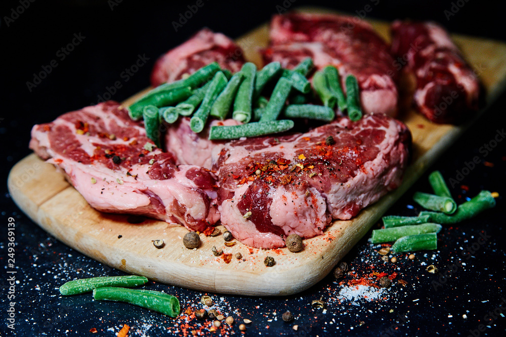 Fresh raw meat pork neck on wooden Board on black table Fresh raw meat pork neck on wooden Board on black table