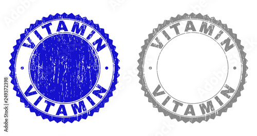 Grunge VITAMIN stamp seals isolated on a white background. Rosette seals with grunge texture in blue and gray colors. Vector rubber stamp imprint of VITAMIN tag inside round rosette.