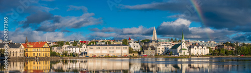 Panoramic view of Reykjavik downtown with lake on Iceland during sunset with rainbow, summer time photo