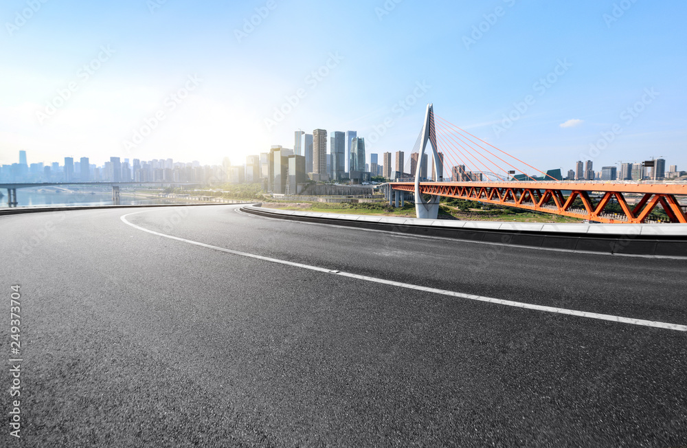 The expressway and the modern city skyline are in Chongqing, China.