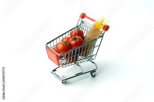 Food minimal concept. Tomatos and spaghetti (tomato pasta) in a toy shopping cart. Tiny kitchen concept. Pop art, contemporary art pattern