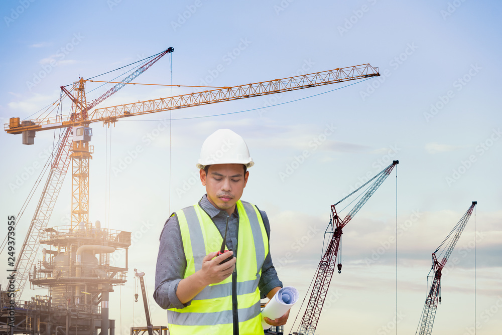 Indian engineer checking work with walkie-talkie for communication to management team in the plant Indian engineer checking work with walkie-talkie for communication to management team in the plant