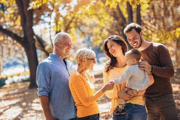 Multl generation family in autumn park having fun